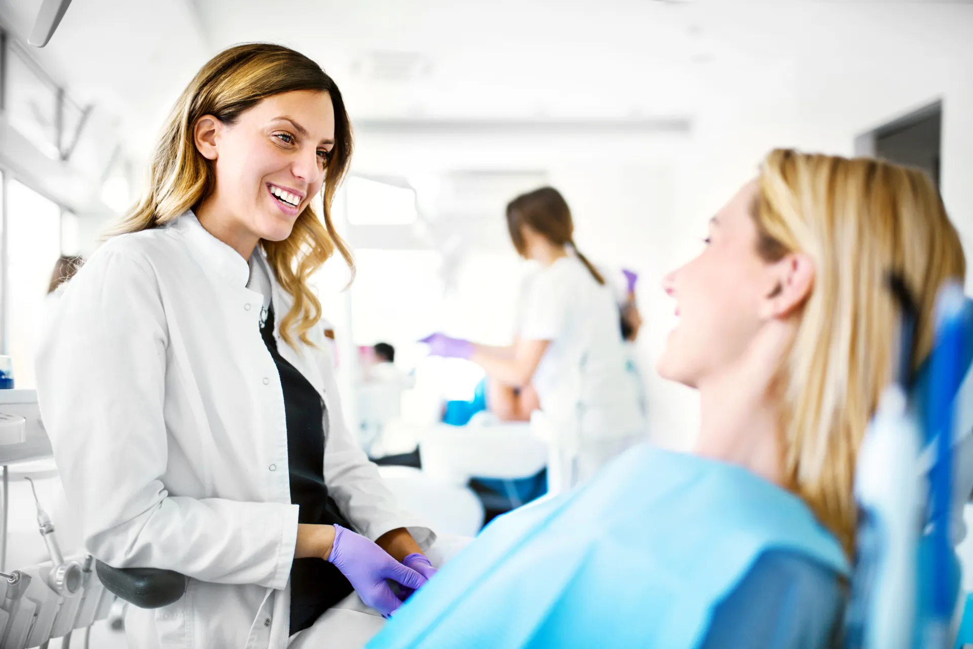 Friendly dentist consulting with a patient in a bright modern dental office
