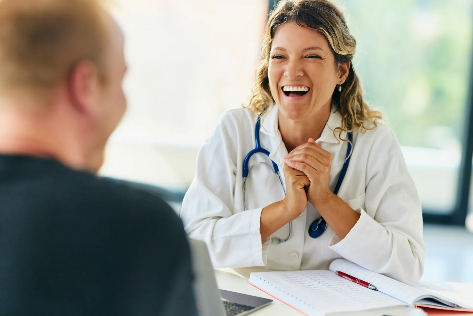Doctor sharing successful patient acquisition results during a strategy review meeting
