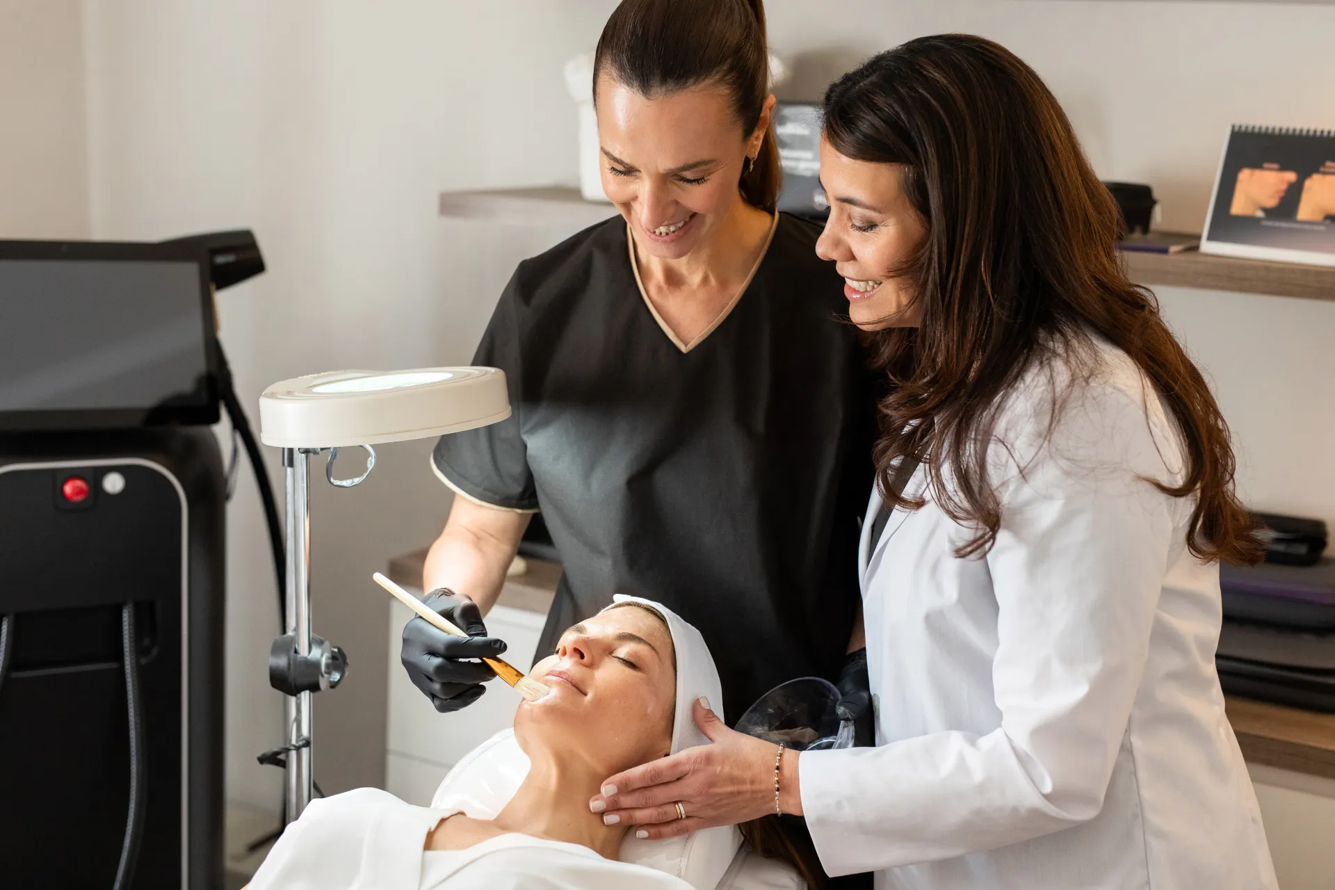 Aesthetic practitioners performing a professional facial treatment in a modern med spa